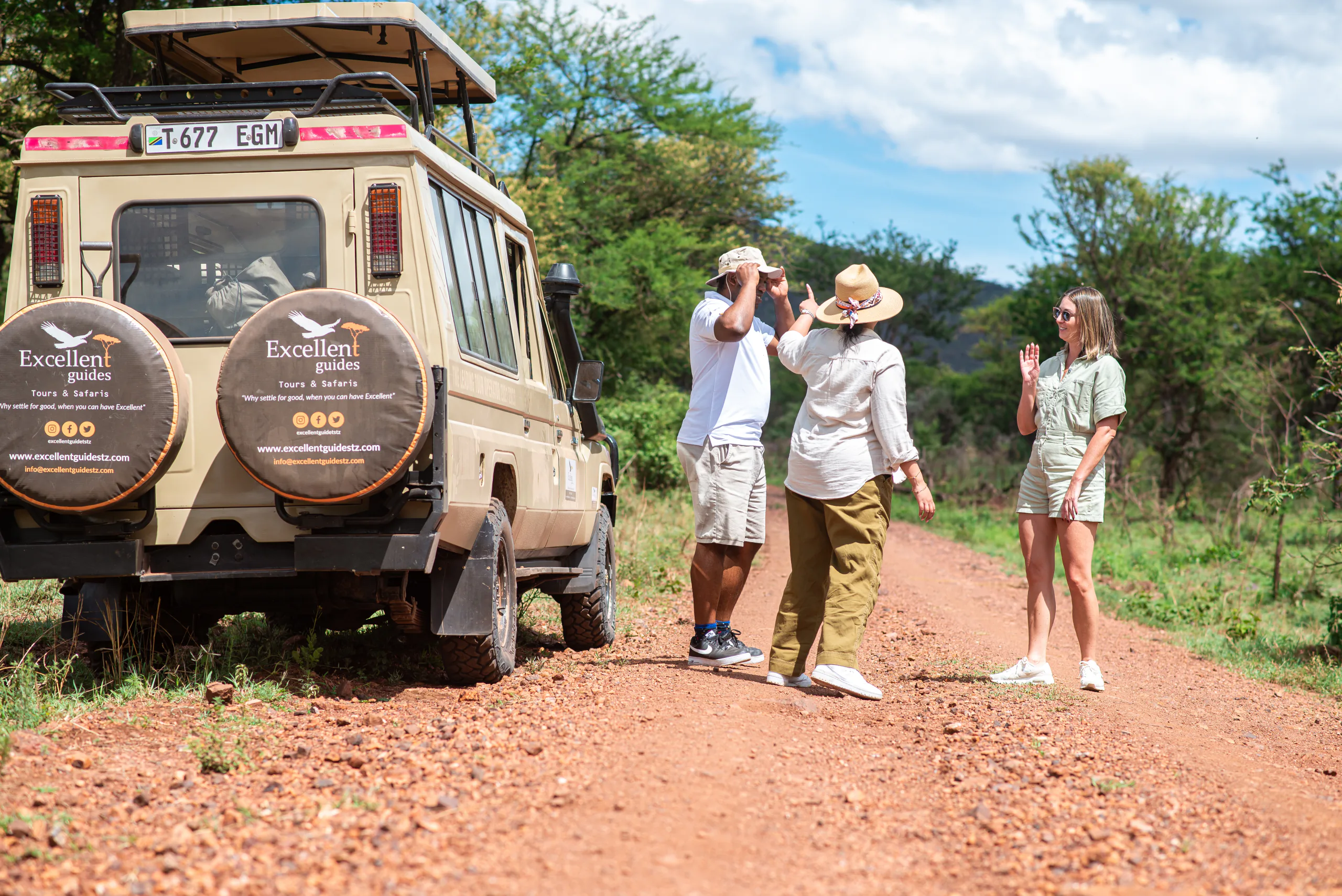 Excellent Guides guests and a safari vehicle preparing for a guided journey
